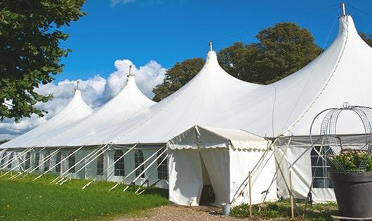 tall green portable restrooms assembled at a music festival, contributing to an organized and sanitary environment for guests in Draper UT